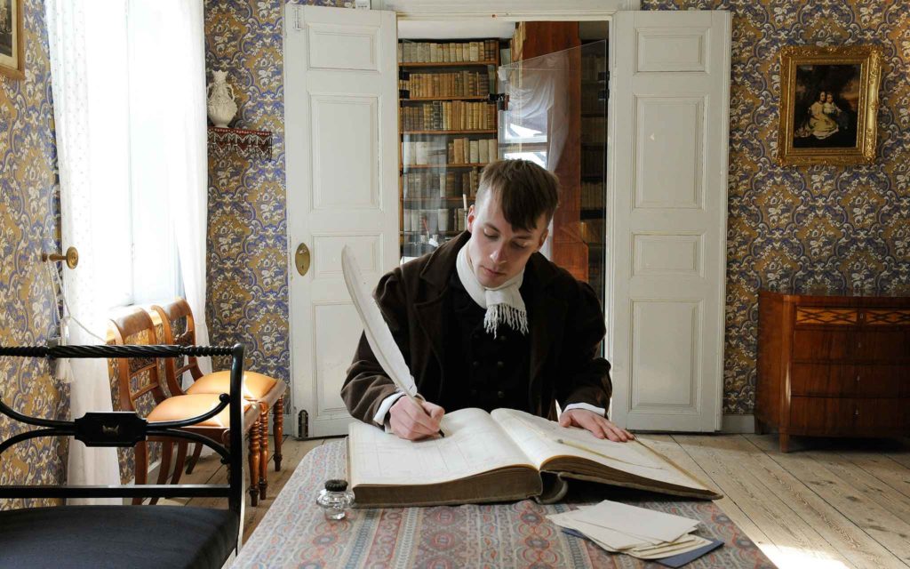 Pedagog Olle Ekström i 1800-talsdräkt i Thomanderska husets övre sal