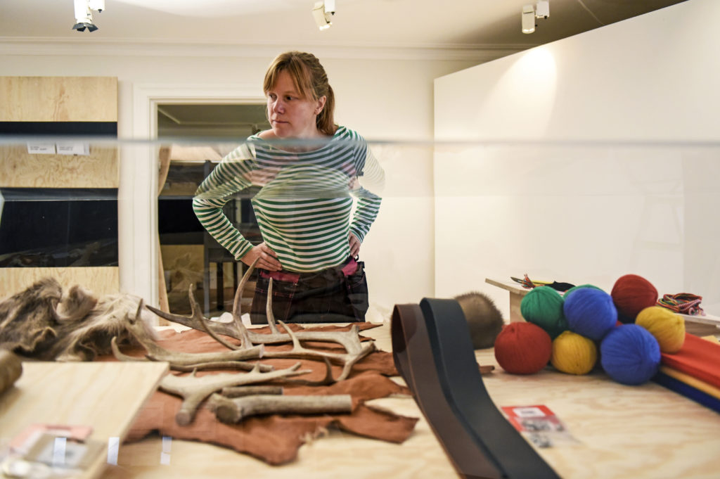 Sofie Bergkvist, utställningsproducent för den kommande utställningen "Fokus Sápmi", tittar ute över renhorn, skinn, garn i samsiska färger med mera i en monter som håller på att färdigställas i utställningen. På Kulturen i Lund.